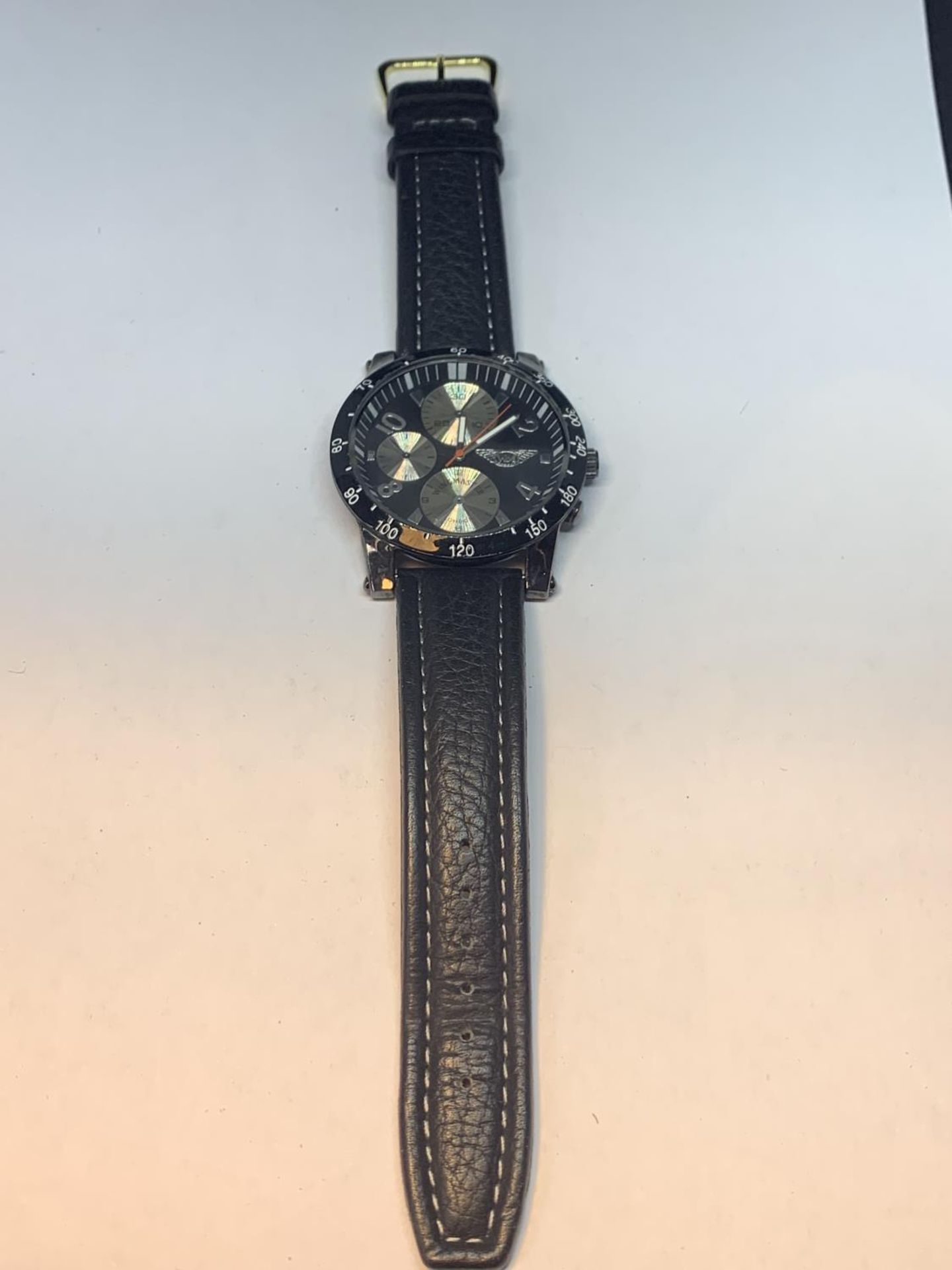 A CHRONOGRAPH WRIST WATCH WITH A BLACK LEATHER STRAP SEEN WORKING BUT NO WARRANTY