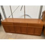 A RETRO TEAK MCINTOSH SIDEBOARD ENCLOSING THREE CUPBOARDS AND THREE DRAWERS 71" WIDE