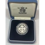 A QUEEN ELIZABETH II SILVER PROOF £1 COIN IN A PRESENTATION BOX