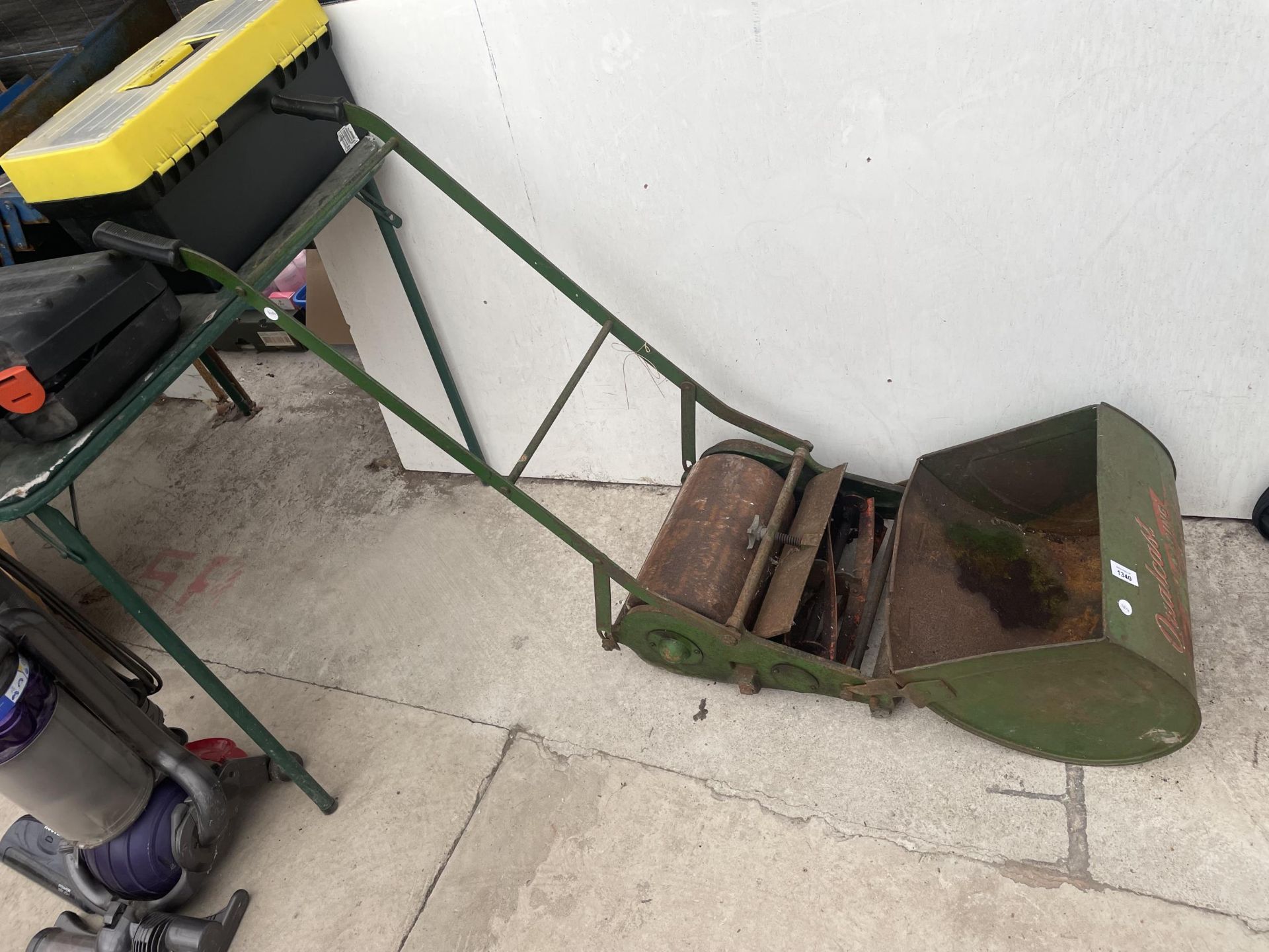 A VINTAGE QUALCAST PUSH LAWNMOWER WITH GRASS BOX