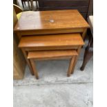 A RETRO TEAK NEST OF THREE TABLES