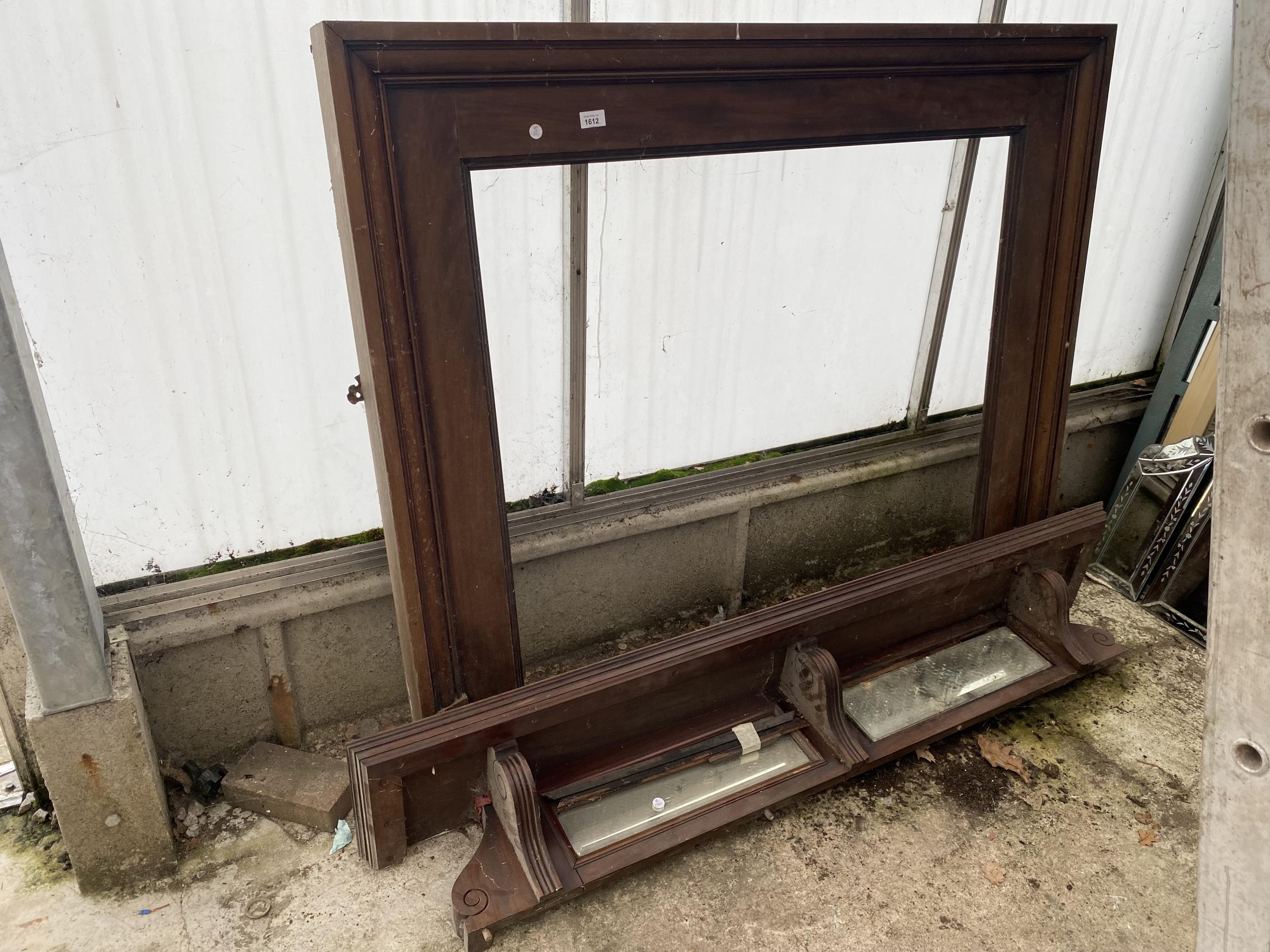 A WOODEN FIRE SURROUND AND A MIRRORED MANTEL SHELF