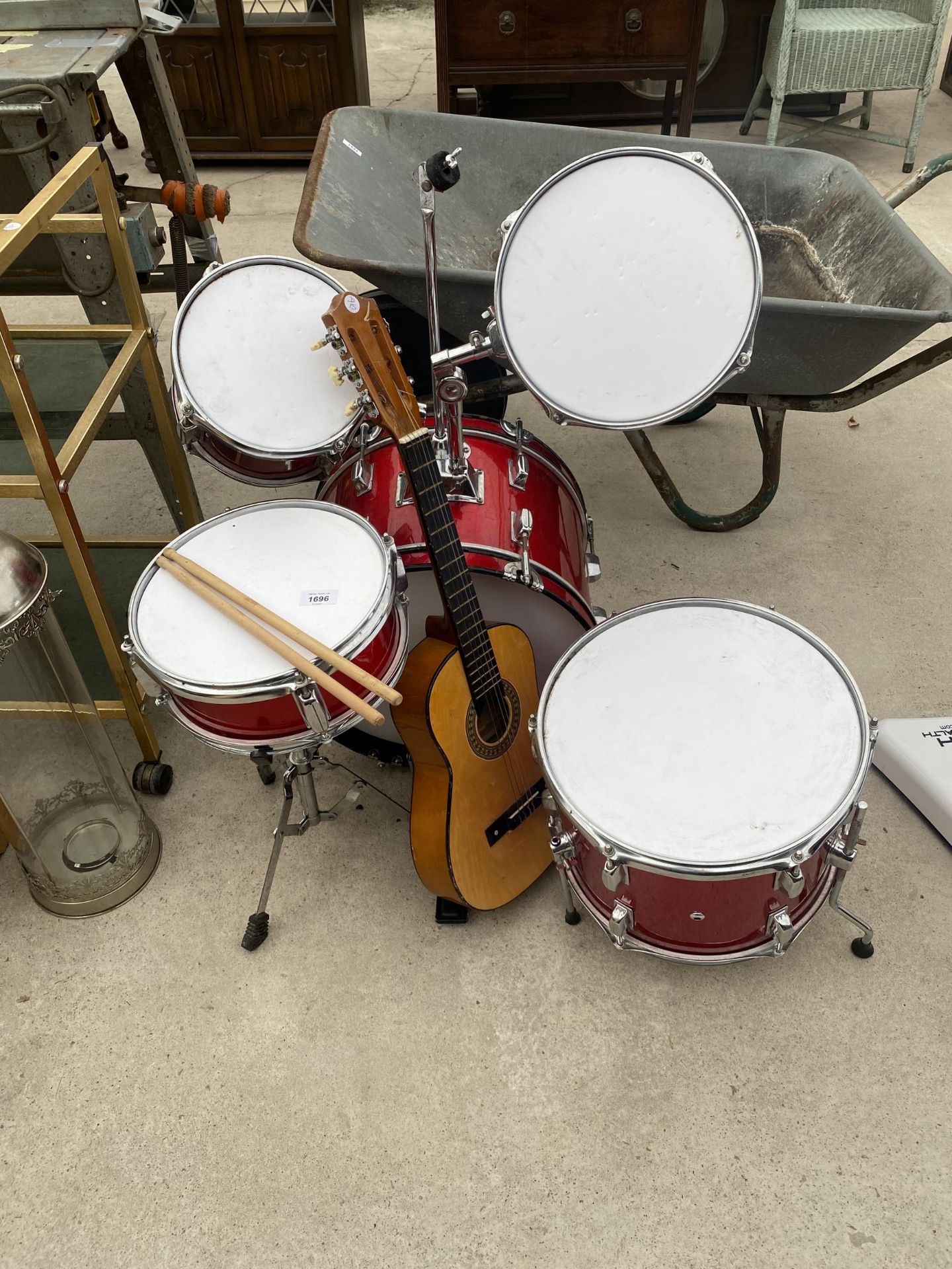 A SMALL CHILDS DRUM KIT AND A CHILDS GUITAR