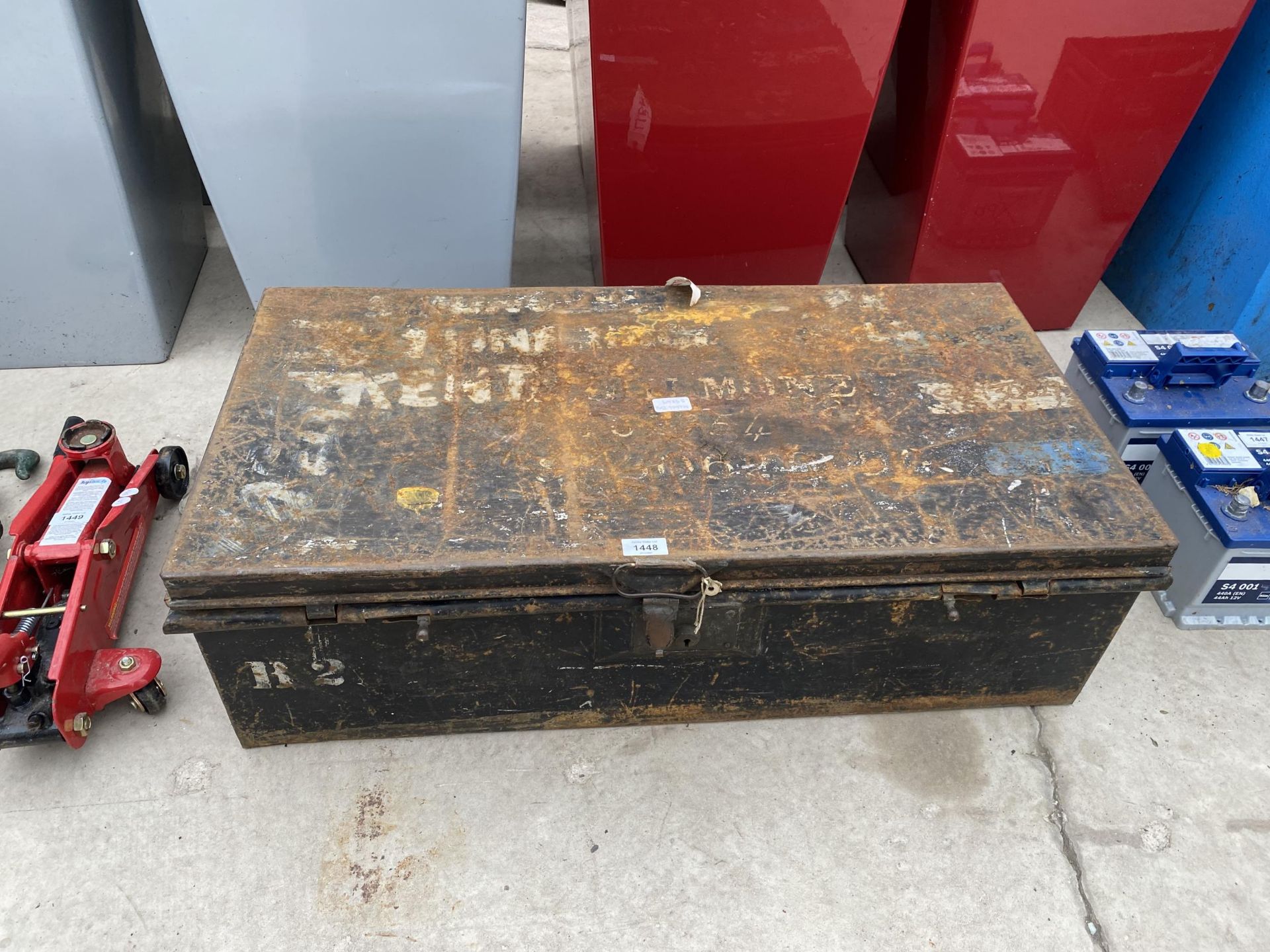 A VINTAGE METAL STORAGE TRUNK WITH CARRY HANDLES AND CLASP