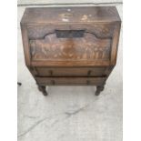 AN EARLY 20TH CENTURY OAK BUREAU WITH TWO DRAWERS ON PINEAPPLE LEGS 29.5 INCHES WIDE