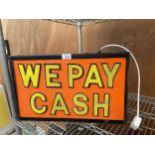 AN ILLUMINATED WE PAY CASH SIGN BELIEVED WORKING BUT NO WARRANTY