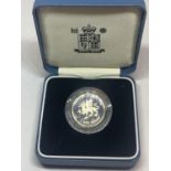 A QUEEN ELIZABETH II SILVER PROOF £1 COIN IN A PRESENTATION BOX