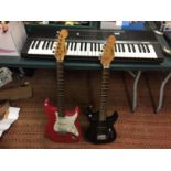 A RED VOLCANO ELECTRIC GUITAR, A BLACK ENCORE ELECTRIC GUITAR AND A CASIO KEYBOARD