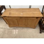 A CONTINENTAL STYLE PINE BLANKET CHEST WITH A THREE PANEL FRONT 44" WIDE