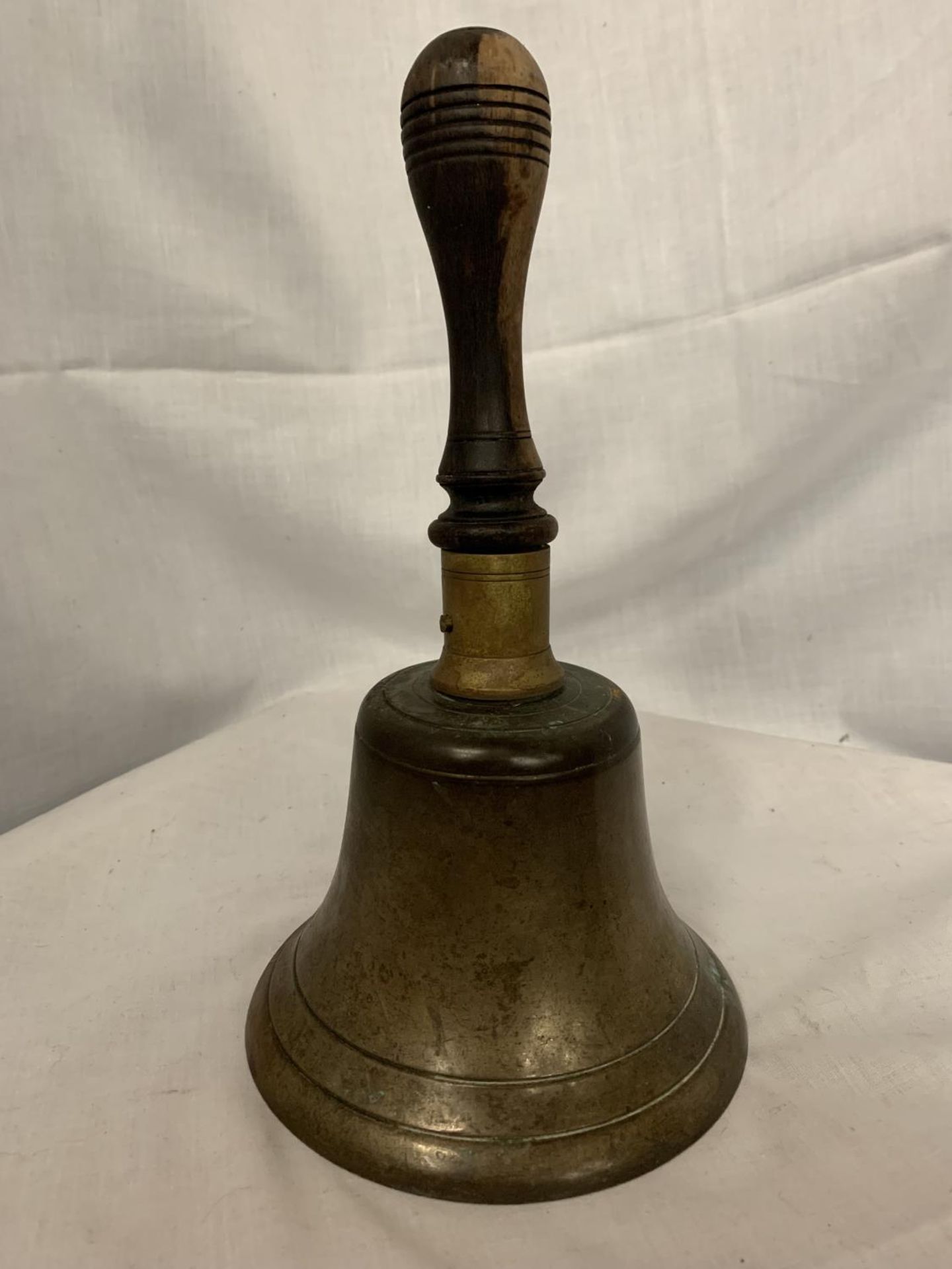 A VINTAGE BRASS SCHOOL BELL WITH WOODEN HANDLE