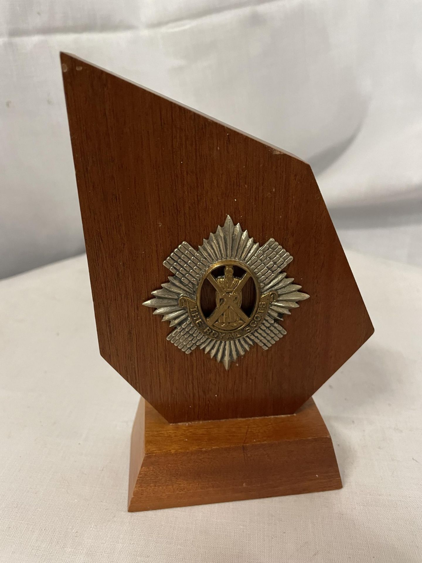 A WOODEN PLAQUE WITH THE ROYAL SCOTS CREST