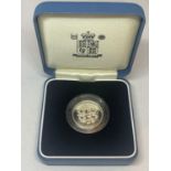 A QUEEN ELIZABETH II SILVER PROOF £1 COIN IN A PRESENTATION BOX