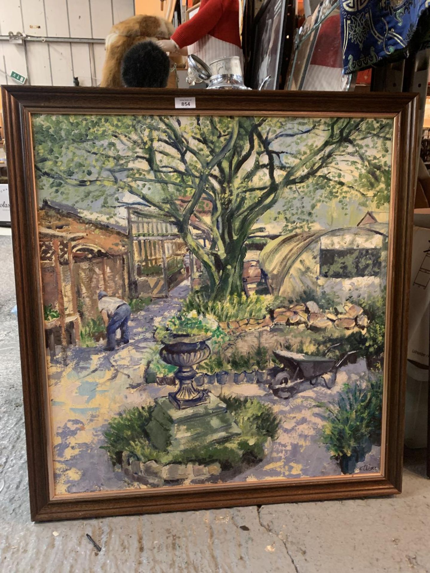 A LARGE PAINTING OF A MAN GARDENING BENEATH A TREE