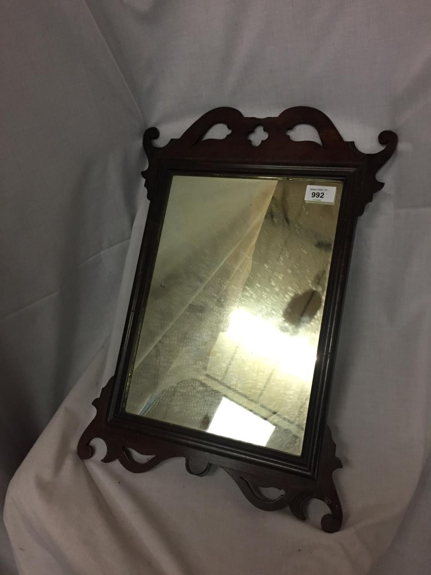 A VINTAGE WOOD FRAMED MIRROR