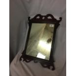 A VINTAGE WOOD FRAMED MIRROR