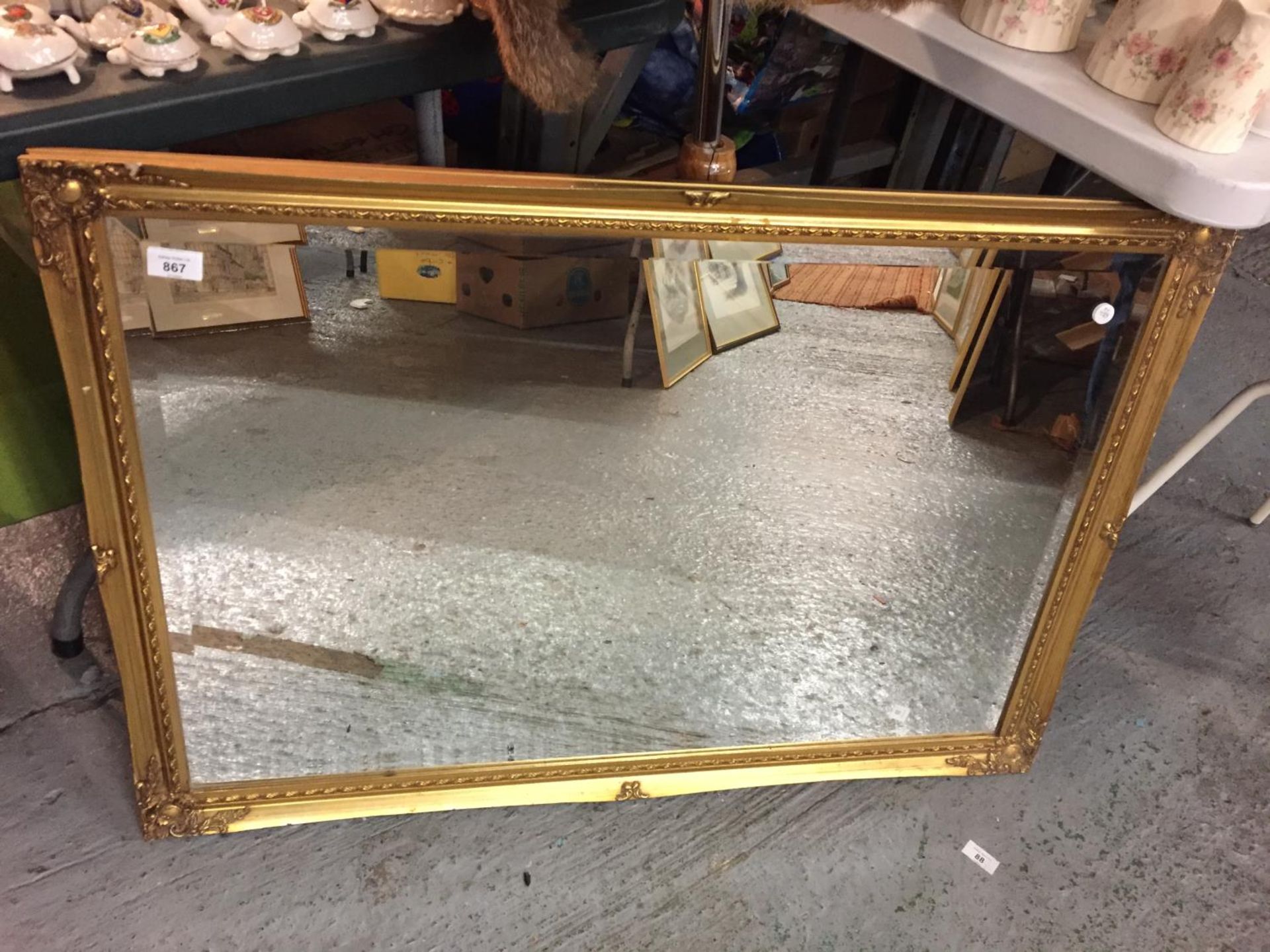 A LARGE GILT FRAMED MIRROR