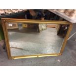 A LARGE GILT FRAMED MIRROR