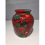 AN ANITA HARRIS HANDPAINTED POINSETTA VASE SIGNED IN GOLD