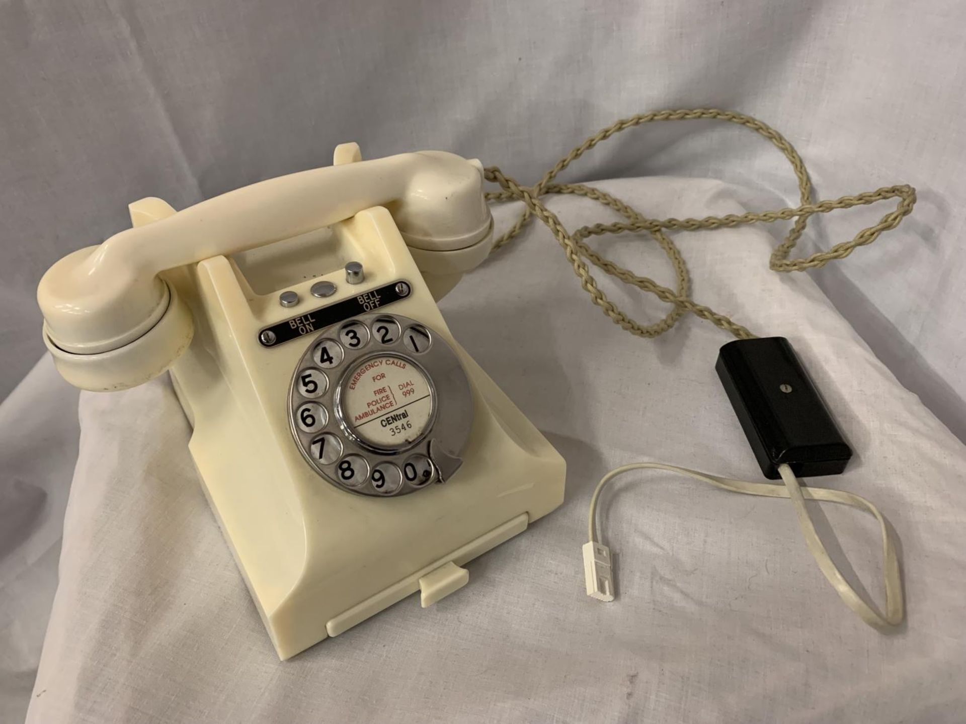 A VINTAGE IVORY BAKELITE TELEPHONE WITH BELL ON/OFF BUTTON AND PULL OUT NUMBER TRAY WIRED FOR MODERN