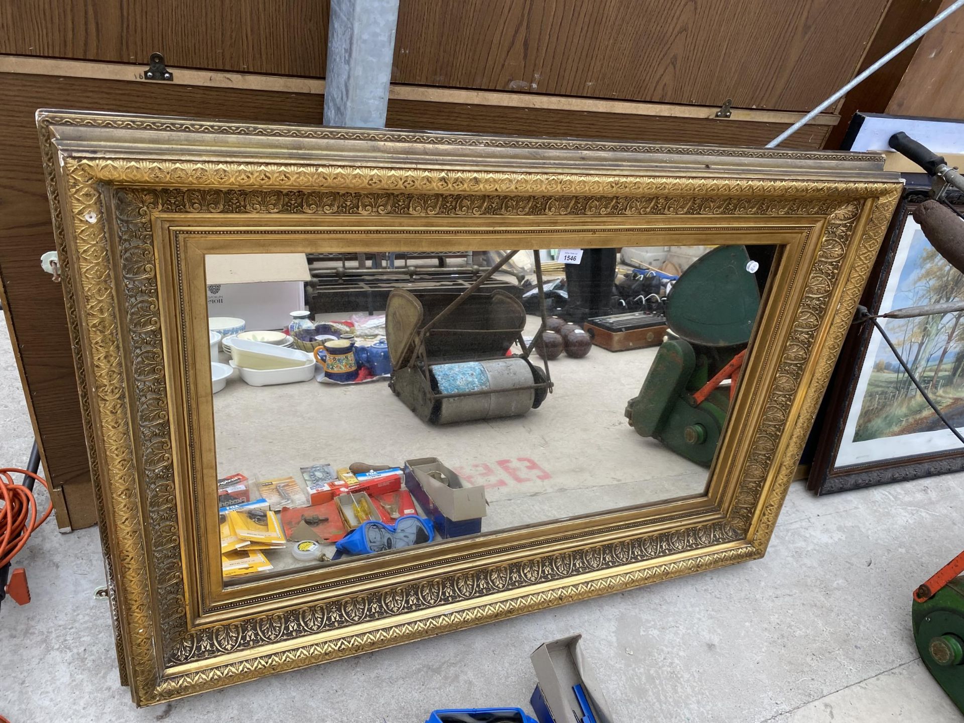 A 19TH CENTURY STYLE GILT FRAMED WALL MIRROR BEARING THE LABEL TO THE BACK 'IN INVENTORY FROM
