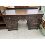 AN OAK JACOBEAN STYLE TWIN-PEDESTAL DESK/DRESSING TABLE WITH LINEN FOLD TOP DRAWERS 48" WIDE