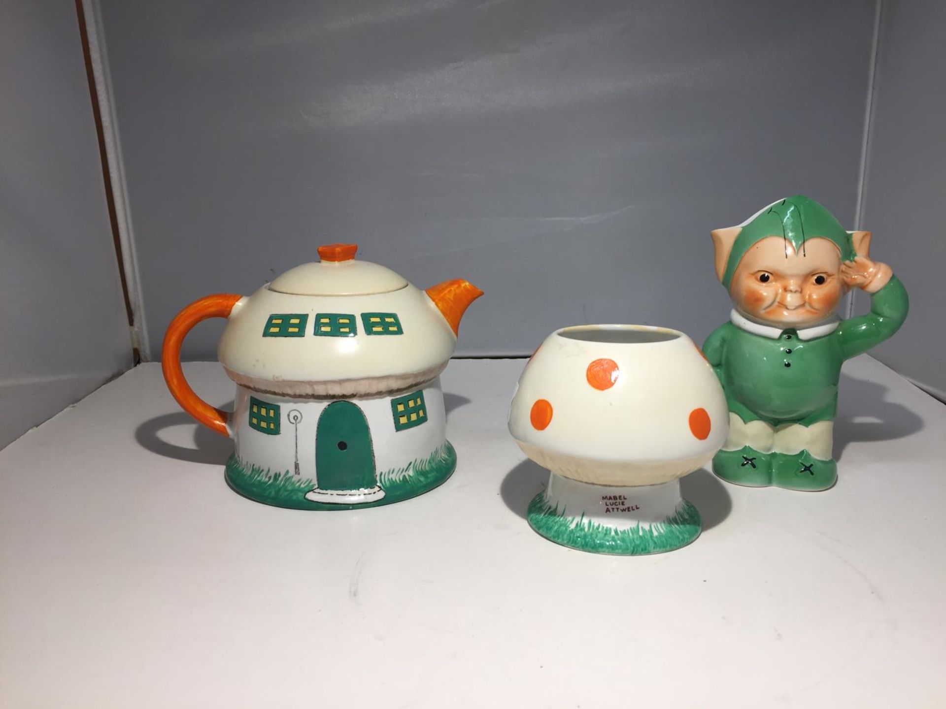 A SHELLEY MABEL LUCIE ATTWELL BOO BOO TEA SET COMPRISING A TEAPOT, SUGAR BOWL AND MILK JUG