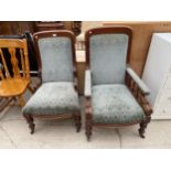 A PAIR OF VICTORIAN GENTLEMAN'S CHAIRS WITH SPRUNG UPHOLSTERY AND TURNED SUPPORTS