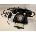 A VINTAGE BLACK BAKELITE TELEPHONE WITH PULL OUT NUMBER TRAY WIRED FOR MODERN USE BUT NO WARRANTY