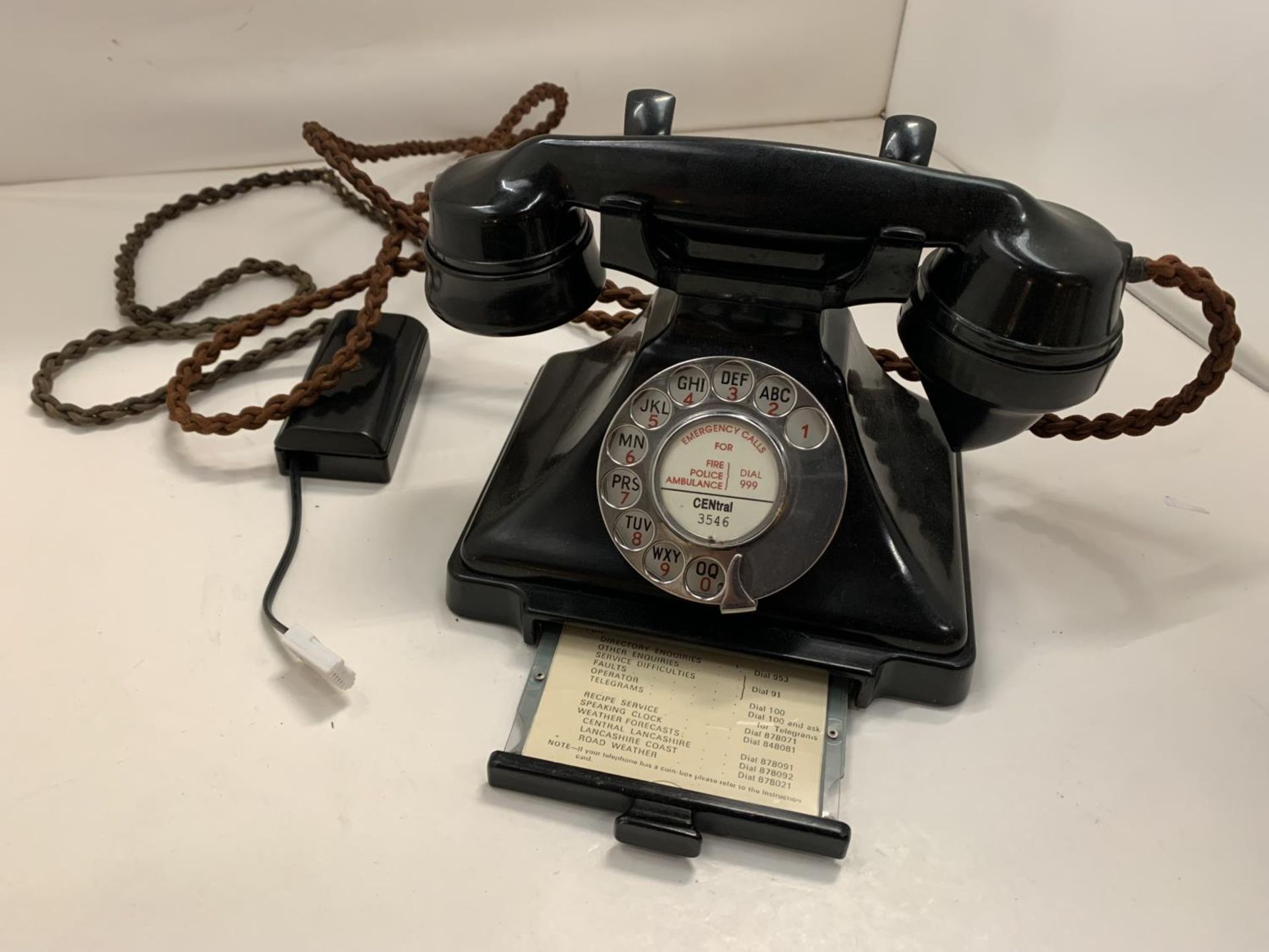 A VINTAGE BLACK BAKELITE TELEPHONE WITH PULL OUT NUMBER TRAY WIRED FOR MODERN USE BUT NO WARRANTY