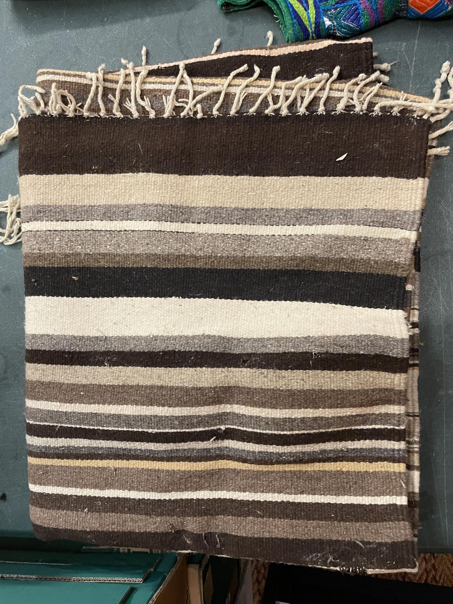 A CREAM AND BROWN RUG