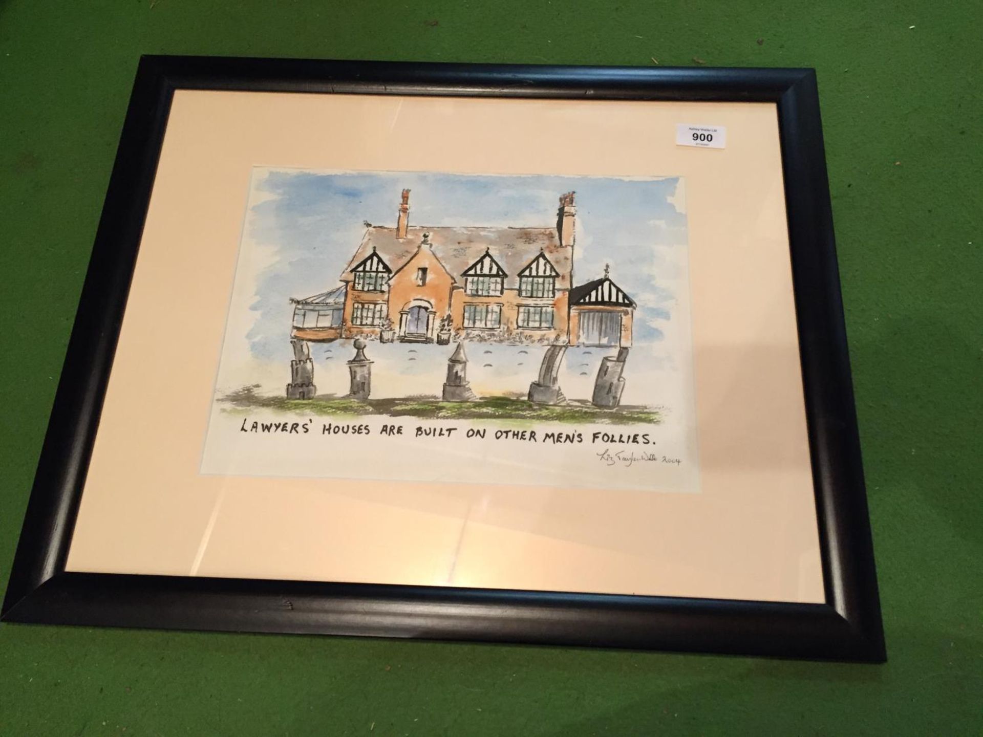 A SIGNED FRAMED PICTURE BY LIZ TAYLOR WEBB 2004, OF A HOUSE SAYING LAWYERS' HOUSES ARE BUILT ON