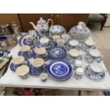 A LARGE ASSORTMENT OF BLUE AND WHITE CERAMIC WARE TO INCLUDE CUPS AND SAUCERS, PLATES, BOWLS AND A