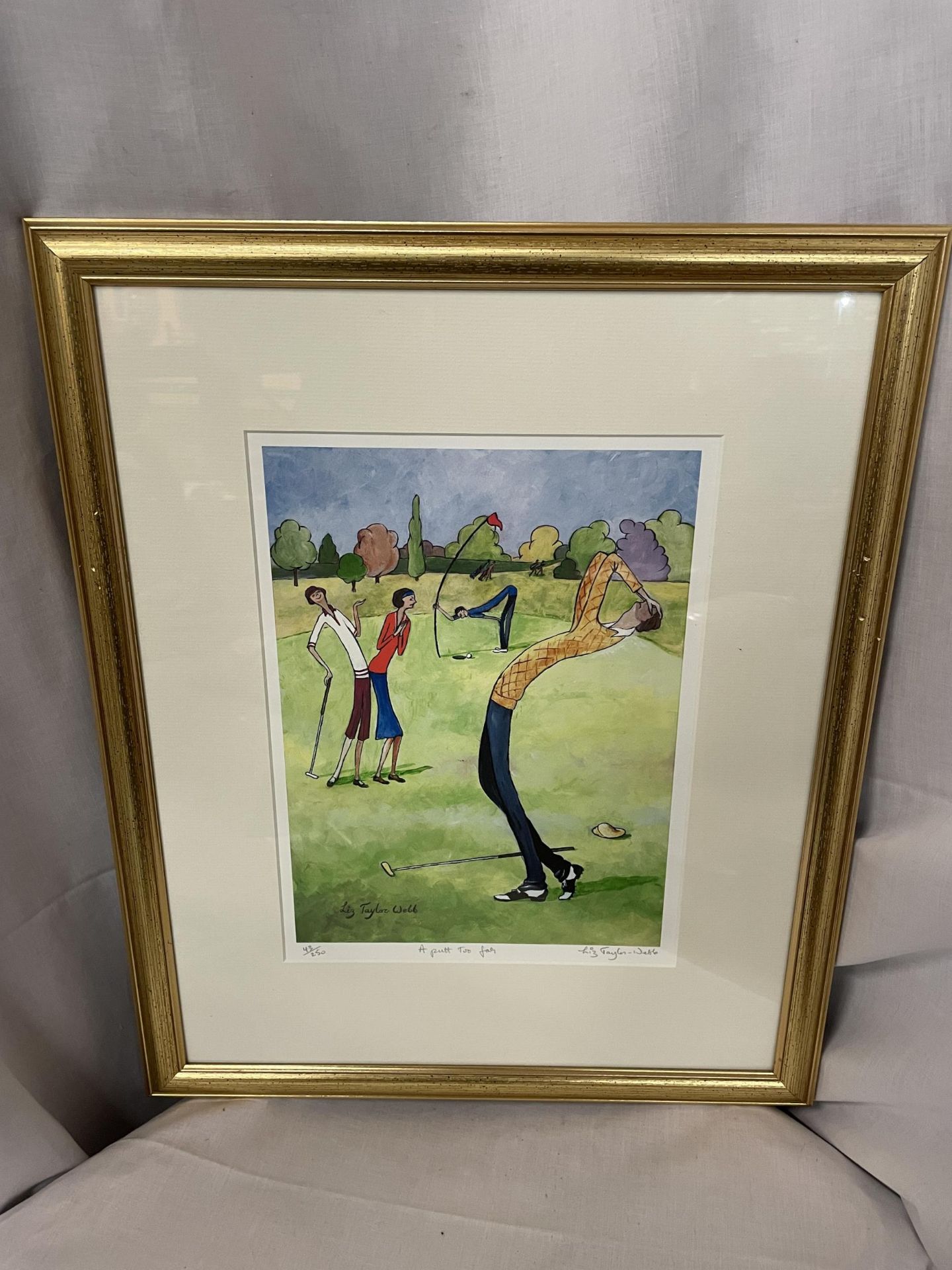 A GILT FRAMED LIMITED EDITION LIZ TAYLOR WEBB PICTURE 'A PUTT TOO FAR' PENCIL SIGNED TO LOWER