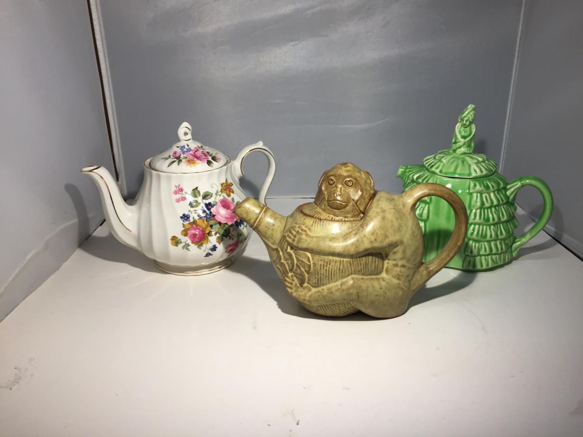 THREE TEAPOTS TO INCLUDE A STONEWARE MONKEY TEAPOT