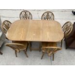 A SET OF SIX MODERN WHEELBACK WINDSOR CHAIRS AND A GATELEG TABLE ON TURNED LEGS 34 INCHES X 58.5