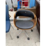 AN EAMES STYLE SWIVEL OFFICE DESK CHAIR WITH FAUX BLACK LEATHER SEAT AND BACK IN BENTWOOD TYPE FRAME