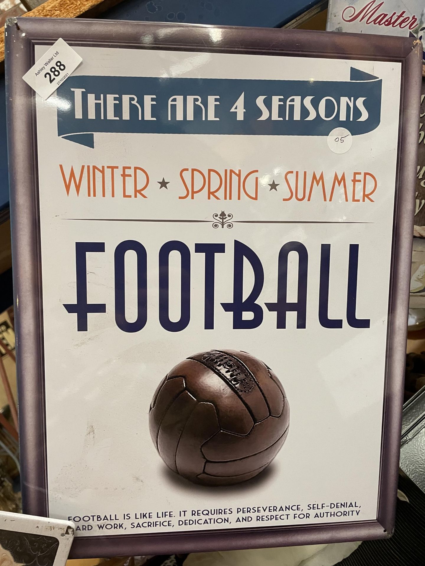 A TIN PLATE SIGN SAYING THERE ARE FOUR SEASONS. WINTER, SPRING, SUMMER, FOOTBALL