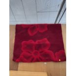 A MODERN RED FLORAL RUG