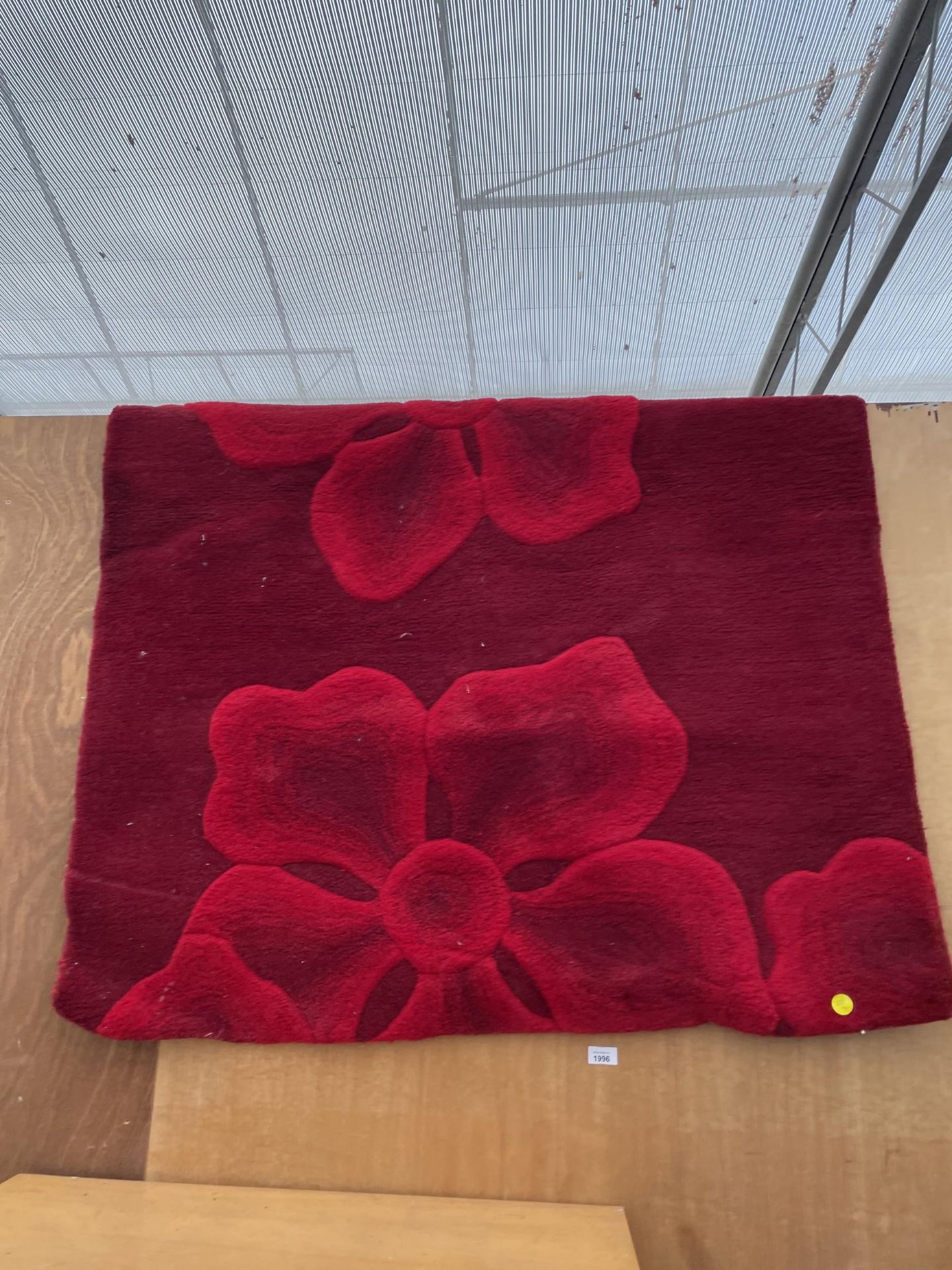 A MODERN RED FLORAL RUG