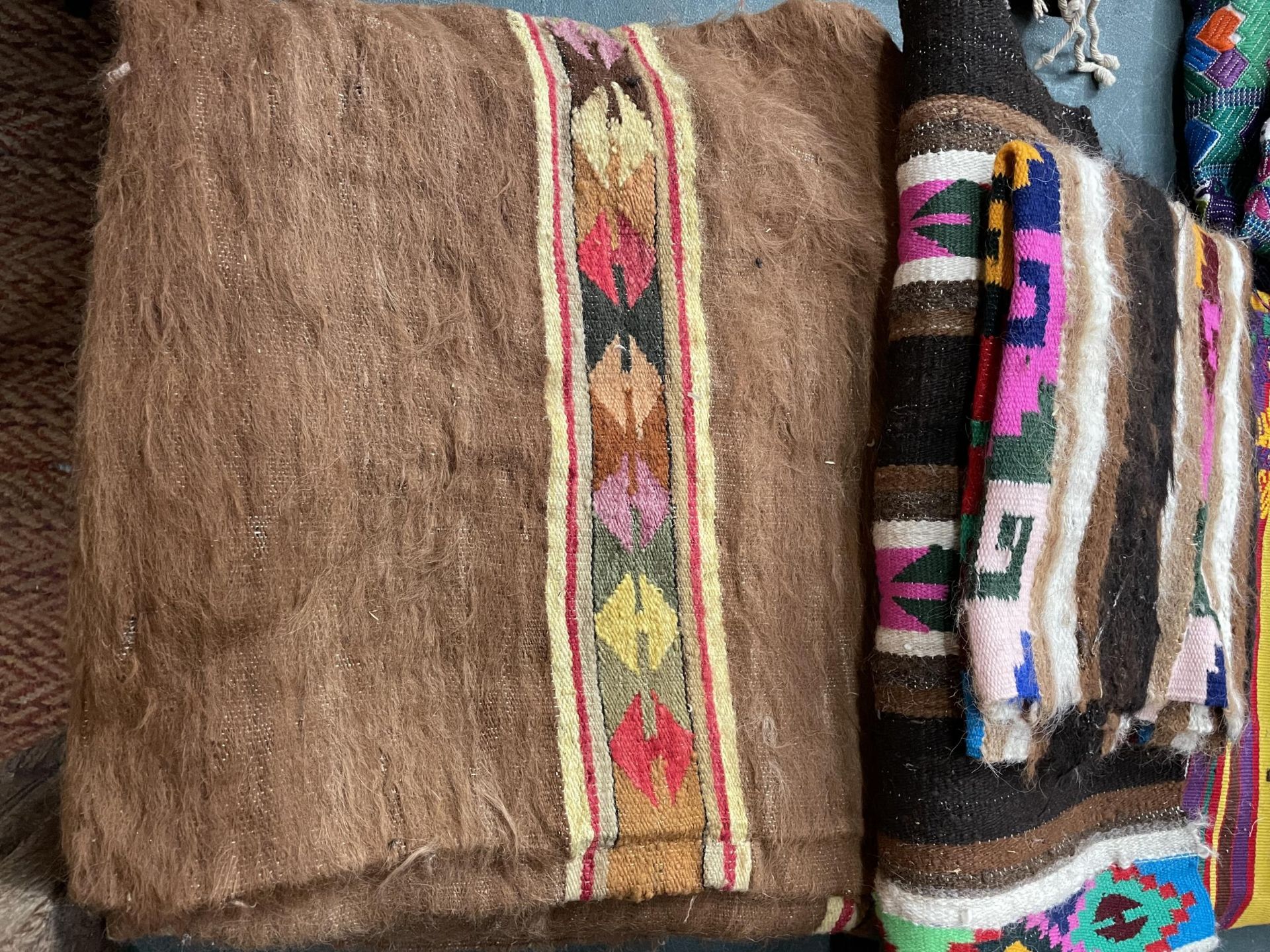 A RUG/THROW AND TWO SMALLER PIECES IN BROWN WITH COLOURED PATTERNS - Image 3 of 3