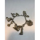 A SILVER CHARM BRACELET WITH TEN CHARMS