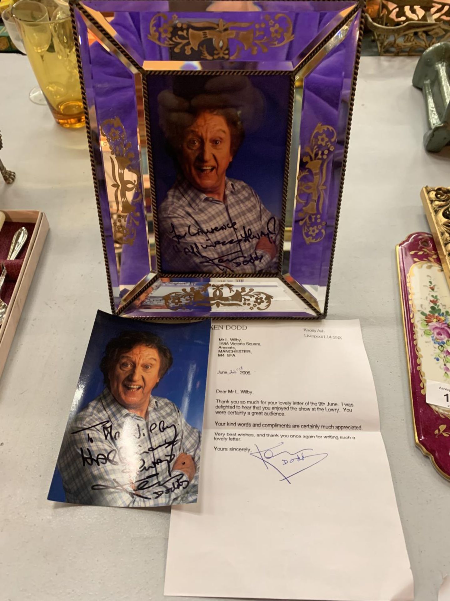 A FRAMED SIGNED PHOTOGRAPH OF KEN DODD, A SIGNED PHOTOGRAPH OF KEN DODD AND A SIGNED LETTER FROM KEN