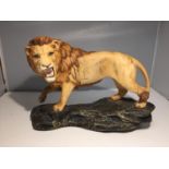 A BESWICK LION ON A ROCK