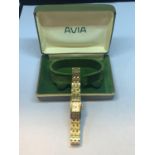 A BOXED VINTAGE AVIA YELLOW METAL WRIST WATCH