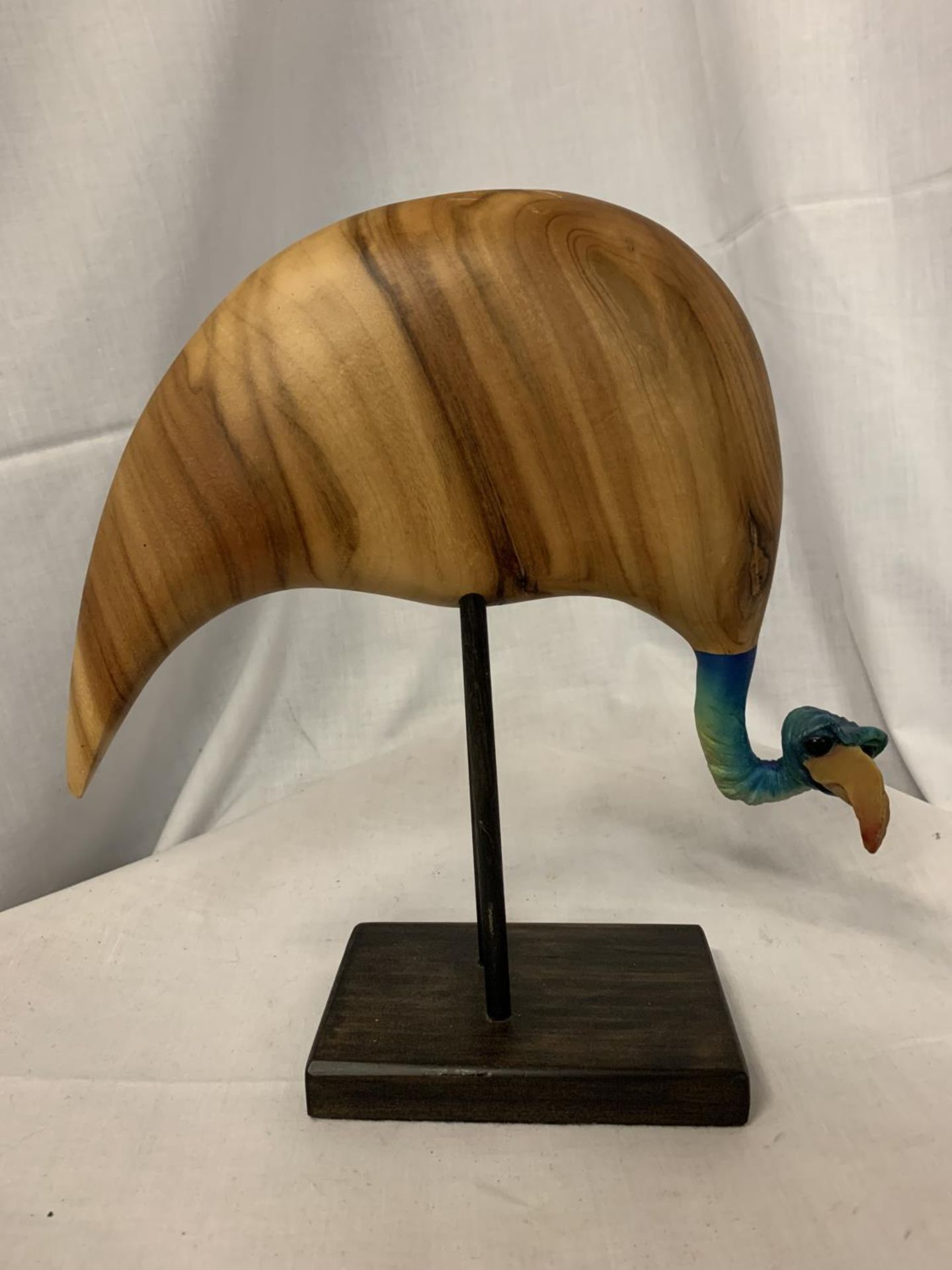 A WOODEN BIRD FIGURE