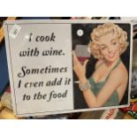 A TIN PLATE SIGN SAYING I COOK WITH WINE. SOMETIMES I EVEN ADD IT TO THE FOOD