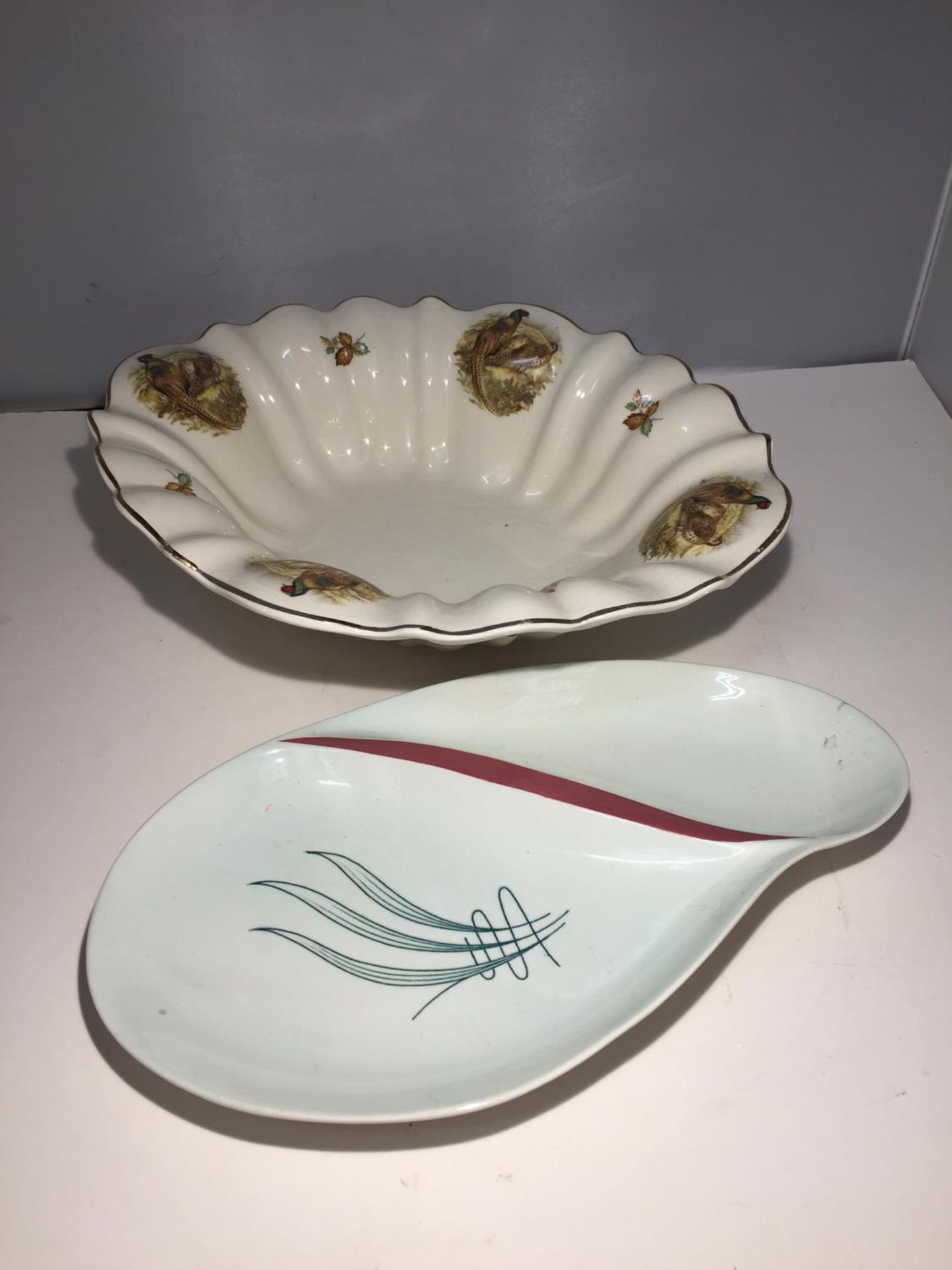 A STAFFORDSHIRE IRONSTONE DISH IN A PHEASANT DESIGN AND A CARLTONWARE SERVING DISH