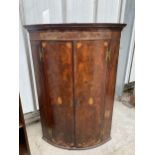 A GEORGE III MAHOGANY AND INLAID TWO DOOR BOW FRONTED CORNER CUPBOARD 28" WIDE
