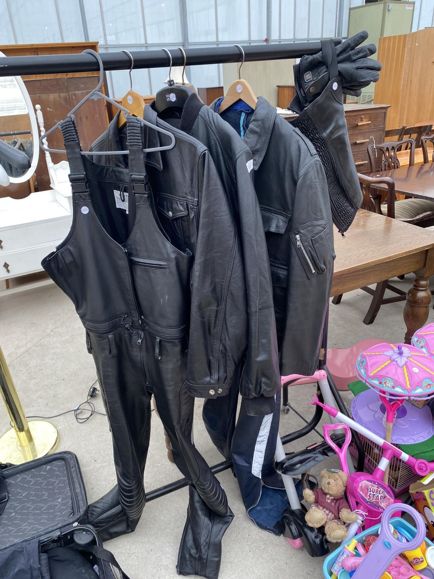 AN ASSORTMENT OF LEATHER CLOTHING ITEMS TO INCLUDE A POLIZEI JACKET AND TROUSSERS ETC