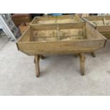 A LARGE WOODEN TROUGH PLANTER (120CM X 84CM X 79CM)